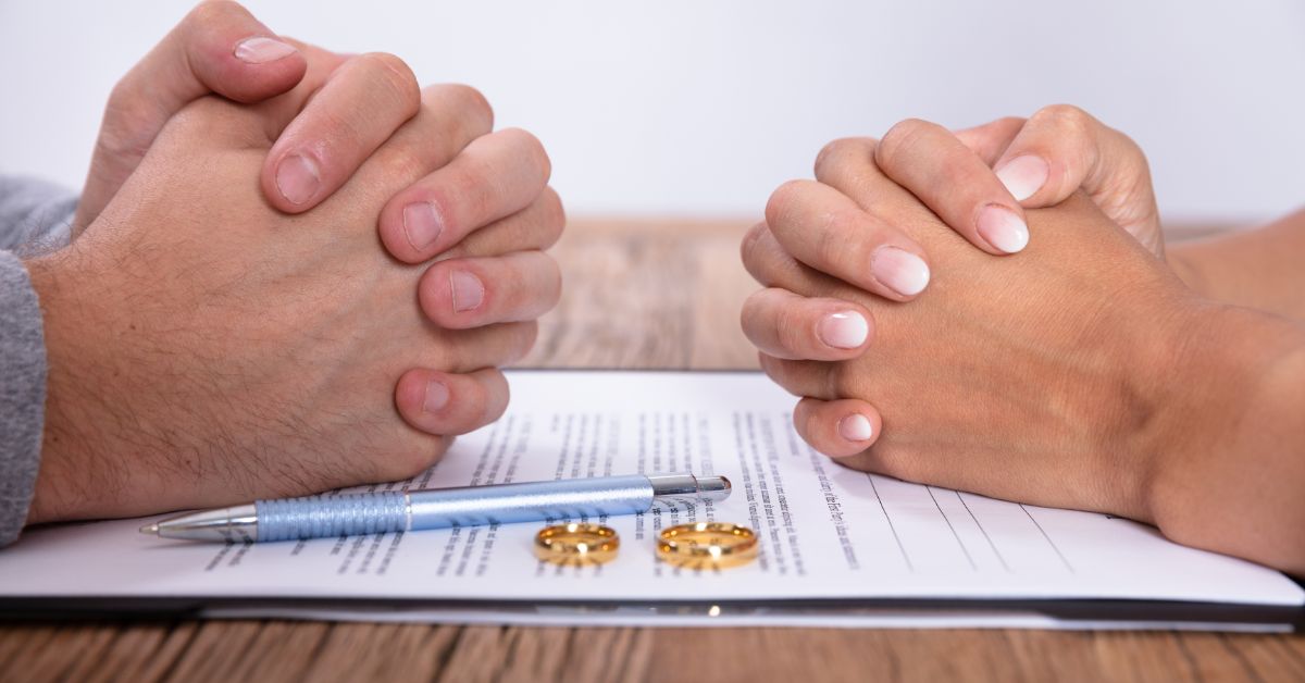 two people with their hands crossed over paperwork and rings